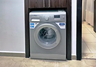a washing machine with a door open in a room at Lovely Studio Apartment in Hanover Square, JVC in Dubai