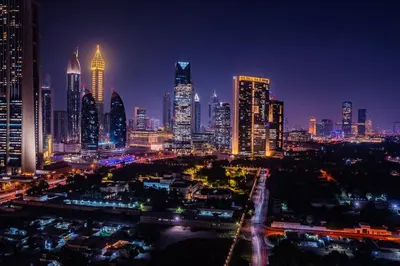 a night view of a city skyline with tall buildings at Phenomenal 2Br in Downtown Views II in Dubai