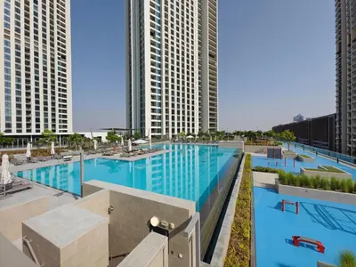 an overhead view of a large swimming pool with tall buildings at Phenomenal 2Br in Downtown Views II in Dubai