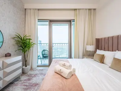 a bedroom with a bed with two towels on it at Phenomenal 2Br in Downtown Views II in Dubai