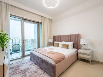 a bedroom with a large bed and a large window at Phenomenal 2Br in Downtown Views II in Dubai
