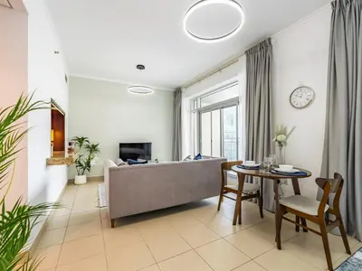 a living room with a couch and a table at Incredible Studio In Burj View in Dubai