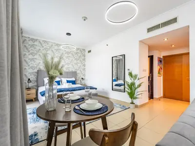 a bedroom with a bed and a table and chairs at Incredible Studio In Burj View in Dubai