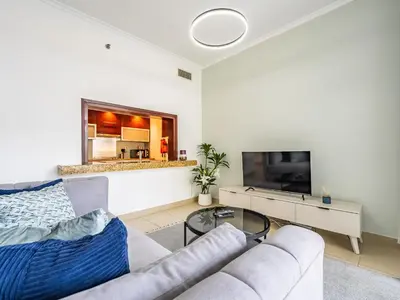 a living room with a couch and a tv at Incredible Studio In Burj View in Dubai