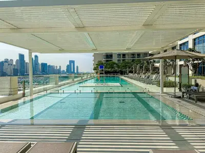 a large swimming pool on top of a building at HiGuests - Emaar Beachfront Haven with Majestic Marina Views in Dubai