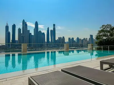 a swimming pool with a view of a city skyline at HiGuests - Emaar Beachfront Haven with Majestic Marina Views in Dubai