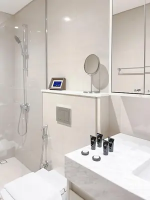 a white bathroom with a sink and a shower at Incredible stay at Burj Royale Downtown in Dubai