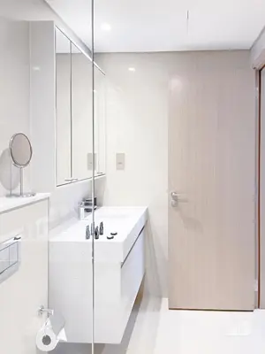 a white bathroom with a shower and a sink at Incredible stay at Burj Royale Downtown in Dubai
