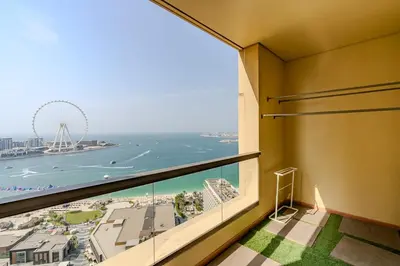 a room with a large window with a view of the beach at JBR Bahar Beach Views 4 beds - DVH Holiday Homes in Dubai