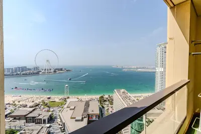 a view of the beach and ferris wheel from a building at JBR Bahar Beach Views 4 beds - DVH Holiday Homes in Dubai