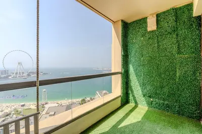 a balcony with a view of the beach and the ocean at JBR Bahar Beach Views 4 beds - DVH Holiday Homes in Dubai