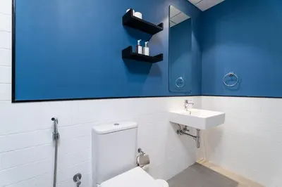 a bathroom with a white toilet and a sink at Nasma Luxury Stays - Home-Style 2BR Apartment with a Balcony View in Dubai