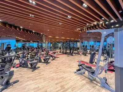 a gym with a lot of treadmills and ellipticals at GuestReady - Lavish studio with Burj Khalifa views in Dubai