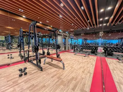a gym with treadmills and exercise equipment in the center at GuestReady - Lavish studio with Burj Khalifa views in Dubai