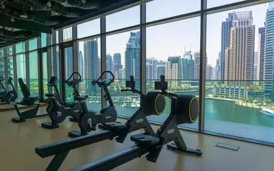 a gym with a view of a city skyline at Dubai Marina Gate 2 Deluxe Apartment in Dubai