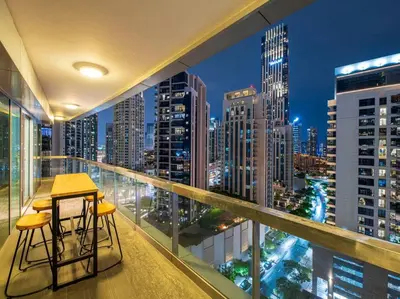 a balcony with a view of a city at night at FIRST CLASS 2BR with Full Boulevard View in Dubai