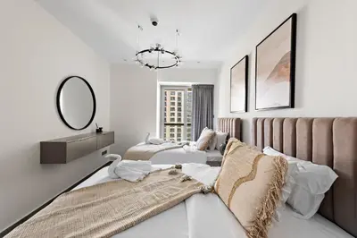 a bedroom with two beds and a mirror at FIRST CLASS 2BR with Full Boulevard View in Dubai