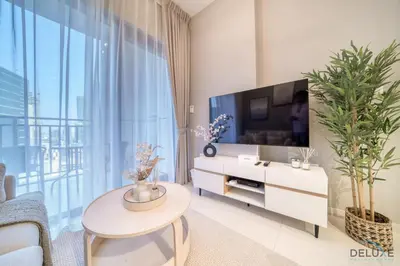 a living room with a large tv and a table at Special Deal Scenic 1BR Close to Burj Khalifa by Deluxe Holiday Homes in Dubai