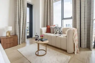 a living room with a couch and a table at Frank Porter - Regina Tower in Dubai