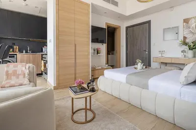a hotel room with two beds and a couch at Frank Porter - Regina Tower in Dubai