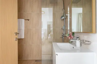 a bathroom with a sink and a shower at Frank Porter - Regina Tower in Dubai