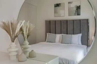 a bedroom with a bed with a mirror on a table at 3BDR with Maid Room I Downtown I Burj Khaliva View in Dubai