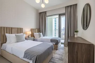 a hotel room with two beds and a large window at 3BDR with Maid Room I Downtown I Burj Khaliva View in Dubai