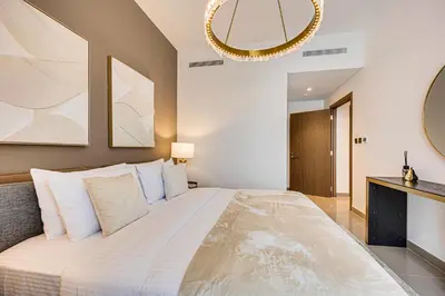 a bedroom with a large bed and a mirror at Pleasant 2BD new apartment in Dubai Creek Harbour in Dubai