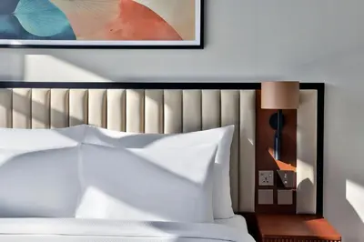 a bedroom with a white bed and a picture on the wall at The First Collection Waterfront, Dubai, a Tribute Portfolio Hotel in Dubai