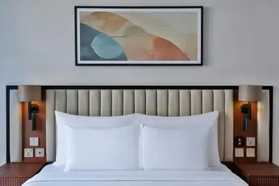 a bedroom with a bed and a picture on the wall at The First Collection Waterfront, Dubai, a Tribute Portfolio Hotel in Dubai