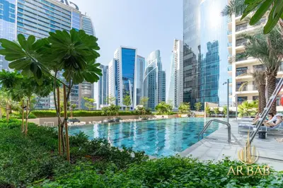 a swimming pool in a city with tall buildings at Arbab Homes Luxury 1BR- Canal View - Damac Zada Tower in Dubai