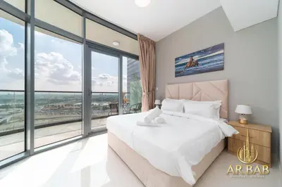 a bedroom with a large bed and large windows at Arbab Homes Luxury 1BR- Canal View - Damac Zada Tower in Dubai