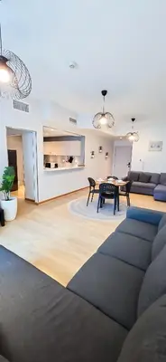 a living room with a couch and a table at Spacious Apartment Marina View in Dubai