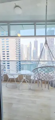 a room with a table and chairs and a large window at Spacious Apartment Marina View in Dubai