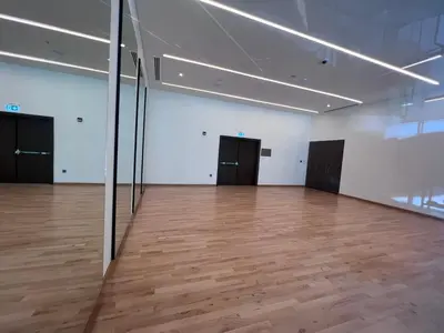 an empty room with a wooden floor and black doors at Forte Downtown Dubai in Dubai