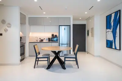 a kitchen and dining room with a table and chairs at Marina Vista 1 Bed with Private Beach and Gorgeous Skyline in Dubai