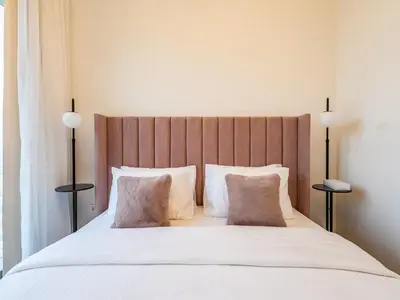 a bedroom with a large white bed with two pillows at Spectacular 2BR in Downtown Views II in Dubai