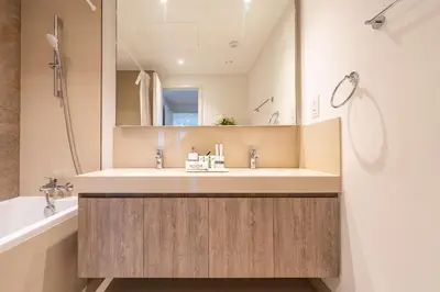 a bathroom with a sink and a mirror at Spectacular 2BR in Downtown Views II in Dubai