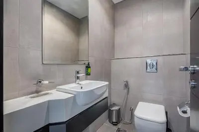 a bathroom with a sink and a toilet at Citihome - 1BR at Merano Tower by Damac in Dubai