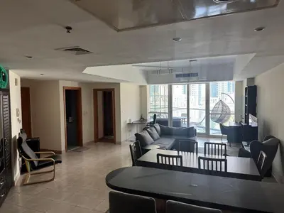a living room with a couch and a table at Stylish Marina View Apartment in Dubai