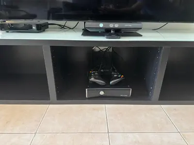 a table with a tv and a video game controller at Stylish Marina View Apartment in Dubai
