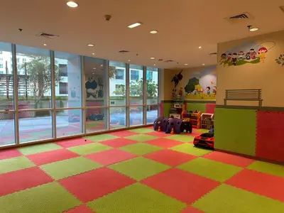 a nursery with a colorful room with a checkerboard floor at Stylish Marina View Apartment in Dubai