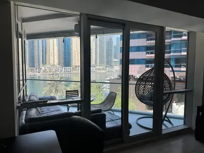 a room with a large window with a view of the city at Stylish Marina View Apartment in Dubai