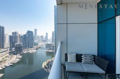 a balcony of a building with a view of a river at Continental Tower, Dubai Marina - Mint Stay in Dubai