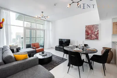 a living room with a couch and a table at Continental Tower, Dubai Marina - Mint Stay in Dubai