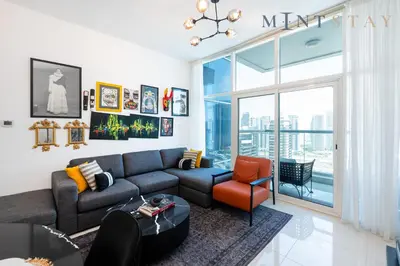 a living room with a couch and a chair at Continental Tower, Dubai Marina - Mint Stay in Dubai
