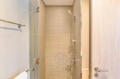 a shower with a glass door in a bathroom at 1BR Zada Tower l Two Balconies & City Views in Dubai