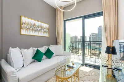 a living room with a white couch and a large window at 1BR Zada Tower l Two Balconies & City Views in Dubai