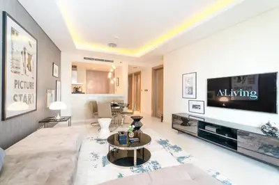 a living room with a couch and a tv at ALiving Classy 1BR I Paramount Towers, Business Bay- 6105 in Dubai