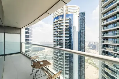 a balcony with a chair and a view of a city at ALiving Classy 1BR I Paramount Towers, Business Bay- 6105 in Dubai